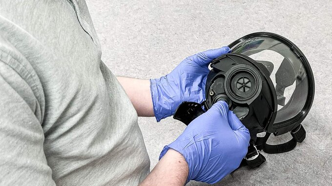 SCBA technician mounts BA mask after drying. SCBA technician mounts BA mask after drying.